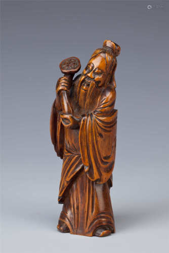 A CHINESE BOX WOOD CARVING OF AN IMMORTAL