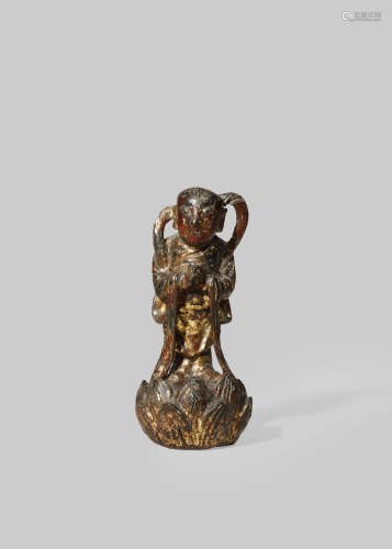 A SMALL GILT AND LACQUERED BRONZE FIGURE OF A BUDDHIST ACOLYTE