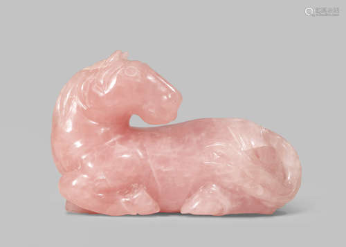 A CHINESE PINK QUARTZ CARVING OF A RECUMBENT HORSE