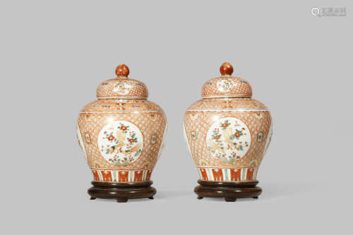 A PAIR OF SMALL CHINESE IRON-RED BALUSTER VASES AND COVERS