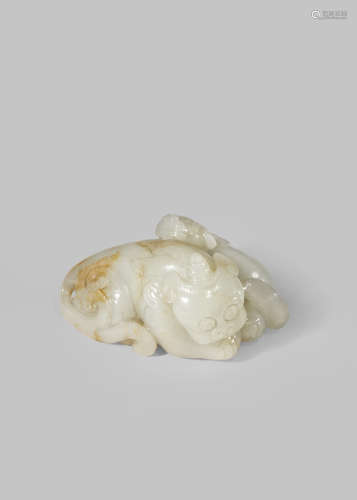 A CHINESE CELADON JADE CARVING OF A QILIN WITH HER PUPPY