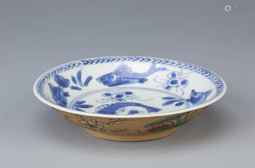 A CHINESE BLUE AND WHITE AND CAFE-AU-LAIT GROUND SAUCER