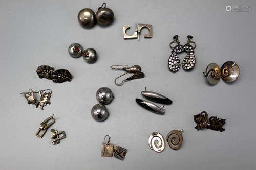 Fourteen pairs of sterling silver earrings.