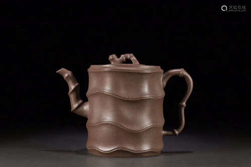 A PURPLE CLAY TEAPOT WITH BAMBOO JOINT