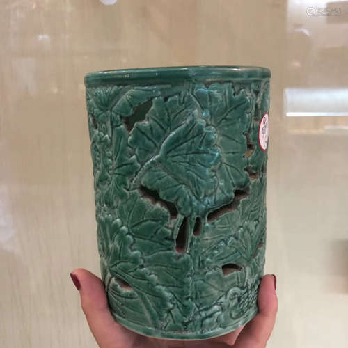 A GREEN GLAZED CARVED PORCELAIN BRUSH HOLDER