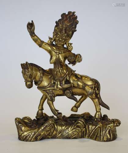 A GILT-BRONZE FIGURE OF DAMCHEN GARWA NAGPO