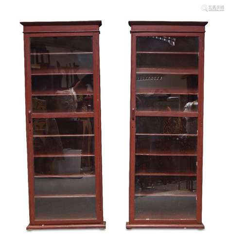 A pair of red painted wall hanging display cabinets