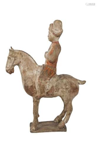 A Chinese pottery figure of a horse and rider