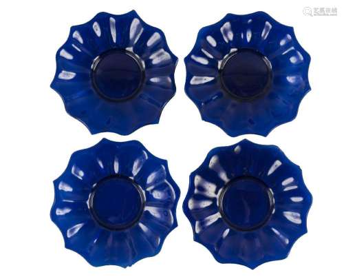Four Chinese Peking blue glass 'lotus' dishes