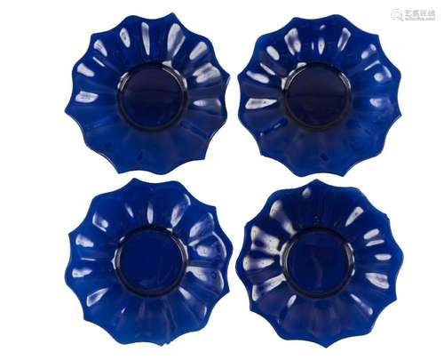 Four Chinese Peking blue glass 'lotus' dishes