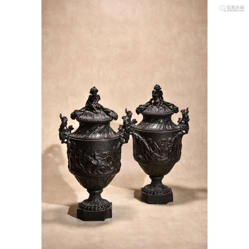 A pair of Continental patinated bronze urns and covers in Rococo taste