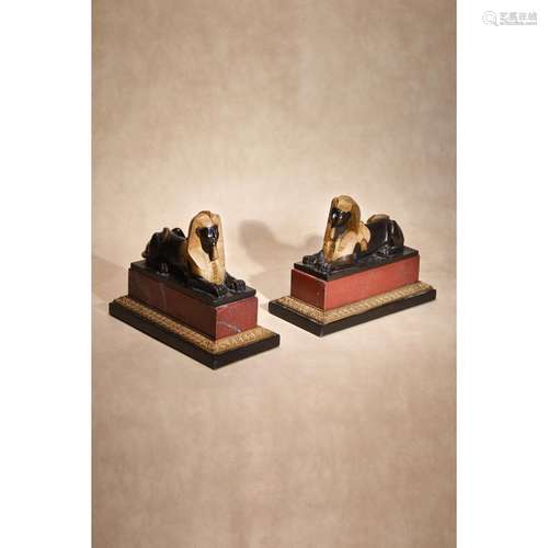 A pair of Continental gilt and patinated bronze and marble mounted models of recumbent sphinges