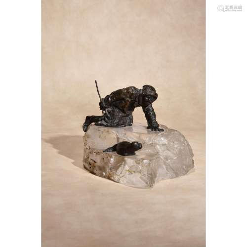 A Russian patinated bronze and rock crystal mounted group of an Inuit hunter and a seal