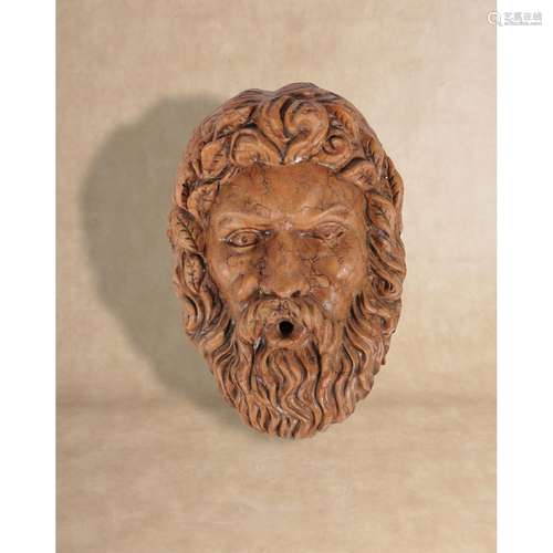 A substantial sculpted marmo Verona wall fount modelled as a bearded Bacchic mask in Baroque taste