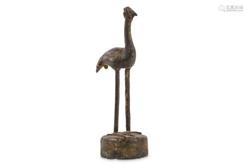 A CHINESE BRONZE FIGURE OF A BIRD. Standing on a c