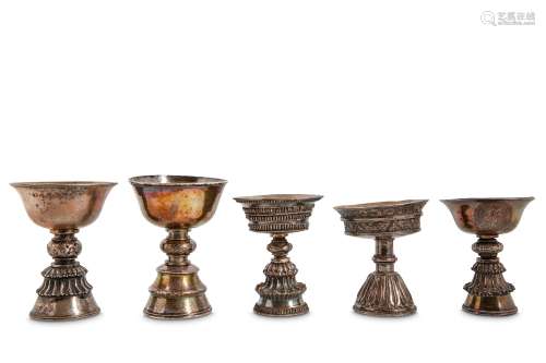 FIVE WHITE METAL BUTTER LAMPS. Tibet, 19th Century