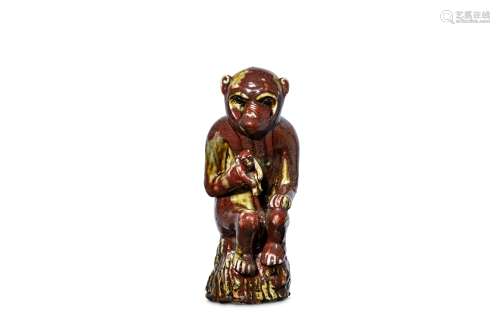 A CHINESE COPPER-RED GLAZED MONKEY. Qing Dynasty,