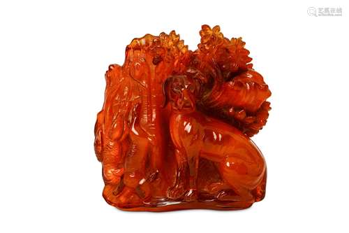 AN AMBER ‘DOG AND GAME’ CARVING. 18th to 19th Century. Well carved to depict a dog seated with the