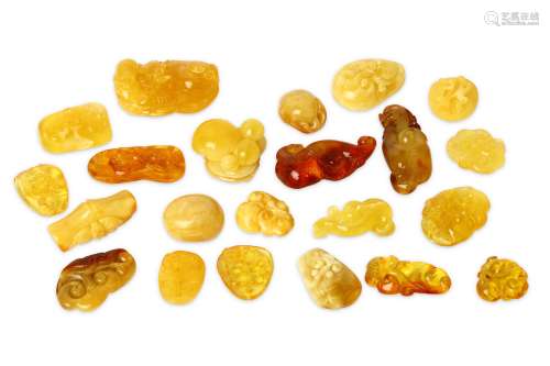 A COLLECTION OF CHINESE AMBER PENDANT CARVINGS.