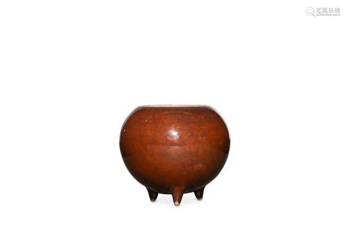 A CHINESE COPPER-RED GLAZED TRIPOD INCENSE BURNER.