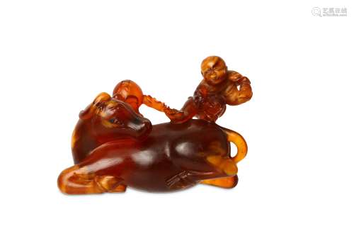 A CHINESE AMBER ‘BOY AND OX’ CARVING. 17th Century