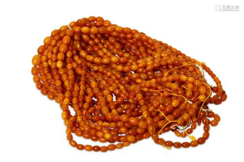 TWENTY AMBER NECKLACES.