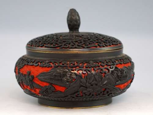 Chinese cinnabar lacquered red and black jar and cover decorated with scrolling foliage and