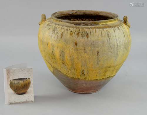 Chinese Zhou dynasty storage jar of ovoid form in a yellow/brown glaze, with loop handles, 23cm