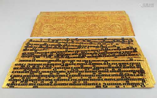 Ten Burmese prayer cards and two boards with gilt and red lacquered decoration, 51.5cm wide,