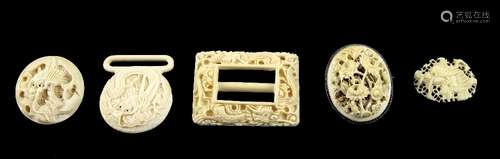 Chinese carved ivory belt buckle with dragon decoration, floral carved ivory brooch and other items,