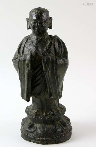 Tibetan bronze figure of a Buddhist monk standing with hands clasped, on lotus base, 21.5cm high,