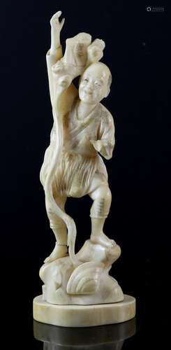 Late 19th/early 20th century Japanese carved ivory figure of a man with a long staff standing on a