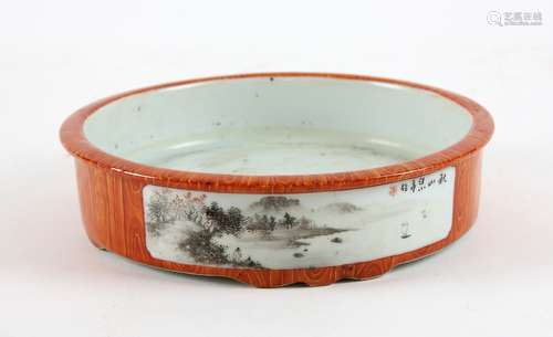 Japanese porcelain orange wood effect dish with two landscape panels, on four shaped feet, iron