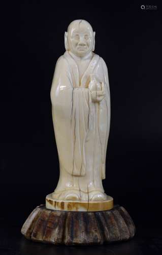 19th century Chinese carved ivory figure of sage in a long robe holding a bottle, 14.5cm high, on