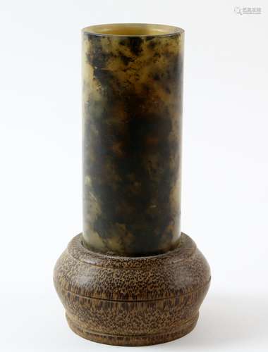 Chinese green and black mottled carved jade cylinder set in a bamboo base, 14cm high,