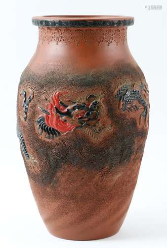 Japanese terracotta vase with moulded decoration of a dragon amongst clouds, marks to base, 25cm