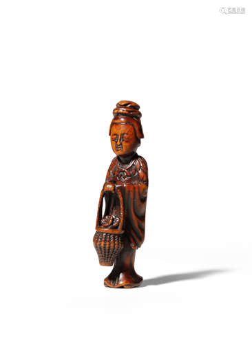 A JAPANESE WOOD NETSUKE EDO 1603-1868 Depicting Seiobo, the Queen Mother of the West, holding a