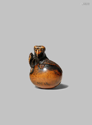 A GOOD JAPANESE WOOD NETSUKE EDO 1603-1868 Depicting a tengu emerging from his egg, tengu no tamago,