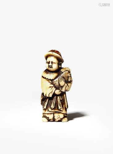 A JAPANESE STAG ANTLER NETSUKE EDO/MEIJI PERIOD Depicting a small child, karako, standing smiling