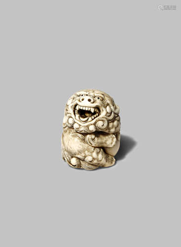 A JAPANESE IVORY NETSUKE OF A LION DOG, SHISHI EDO 1603-1868 The mythical beast seated on its