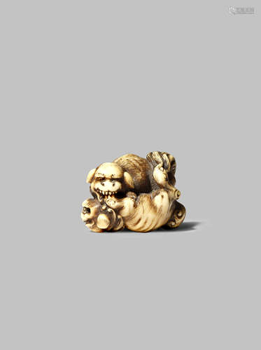 A JAPANESE IVORY NETSUKE EDO 1603-1868 Carved as two shishi play fighting, one on top of the other