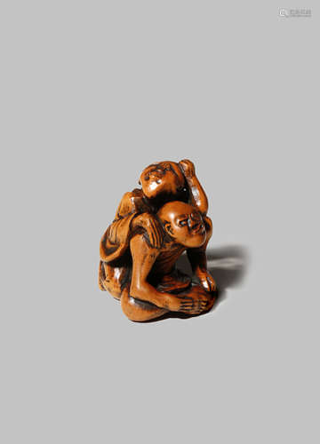 A JAPANESE WOOD NETSUKE EDO/MEIJI PERIOD Carved as a blind masseur and his client, the first