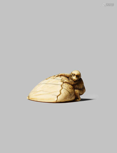 A JAPANESE IVORY NETSUKE EDO 1603-1868 Carved as a small monkey climbing upon a giant chestnut,