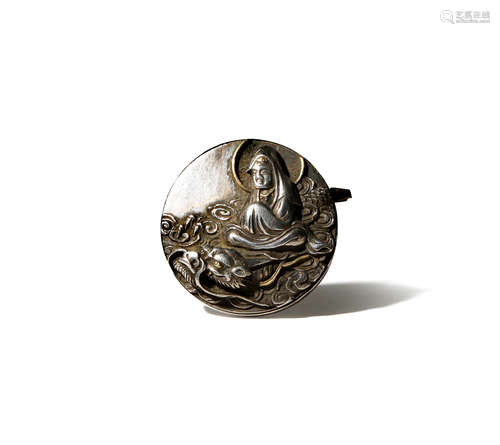 A JAPANESE SILVER ADAPTED OBIDOME EDO/MEIJI PERIOD Of circular shape, decorated with Ryuzu Kannon