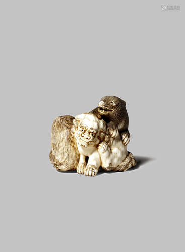 A JAPANESE IVORY NETSUKE MEIJI 1868-1912 Depicting the unusual subject of a shishi, a bear and a