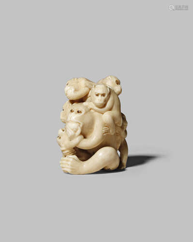 A JAPANESE IVORY NETSUKE MEIJI 1868-1912 Depicting a large monkey eating a peach, with five