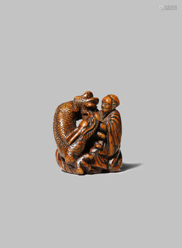 A JAPANESE WOOD NETSUKE EDO 1603-1868 Carved as Handaka Sonja with his pet dragon, the bearded