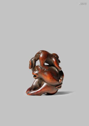 A JAPANESE WOOD NETSUKE MEIJI 1868-1912 Carved as two monkeys, the largest seated and holding the