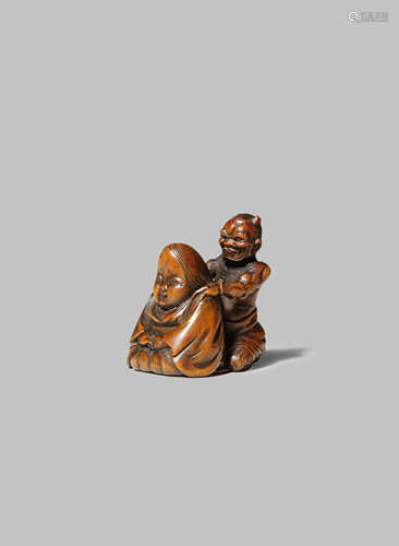 A JAPANESE WOOD NETSUKE EDO/MEIJI PERIOD Carved as an oni giving Okame a massage, the demon