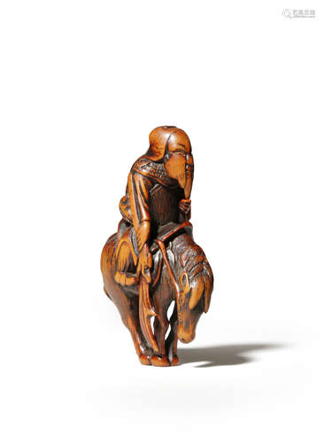 A JAPANESE WOOD NETSUKE EDO 1603-1868 Carved as Kan'u riding his horse, the Chinese general with